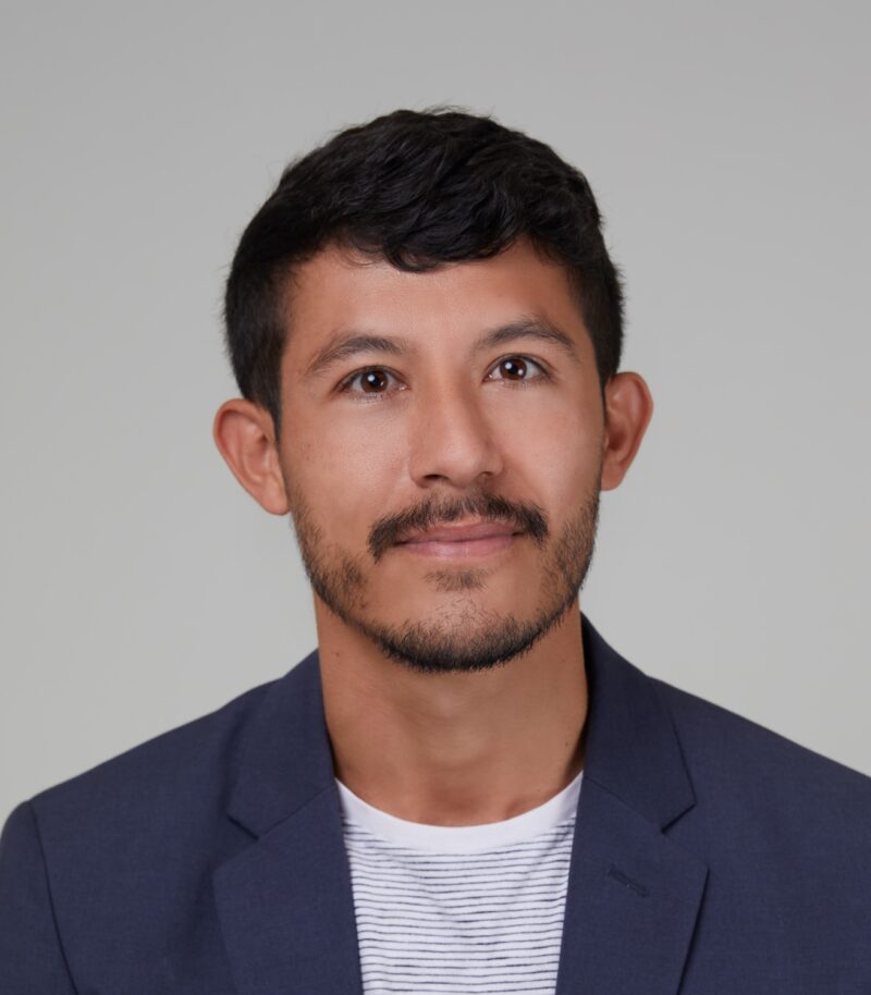 A man with short hair and beard wearing a jacket.