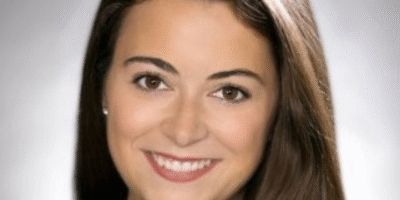 A woman with long hair and a smile.